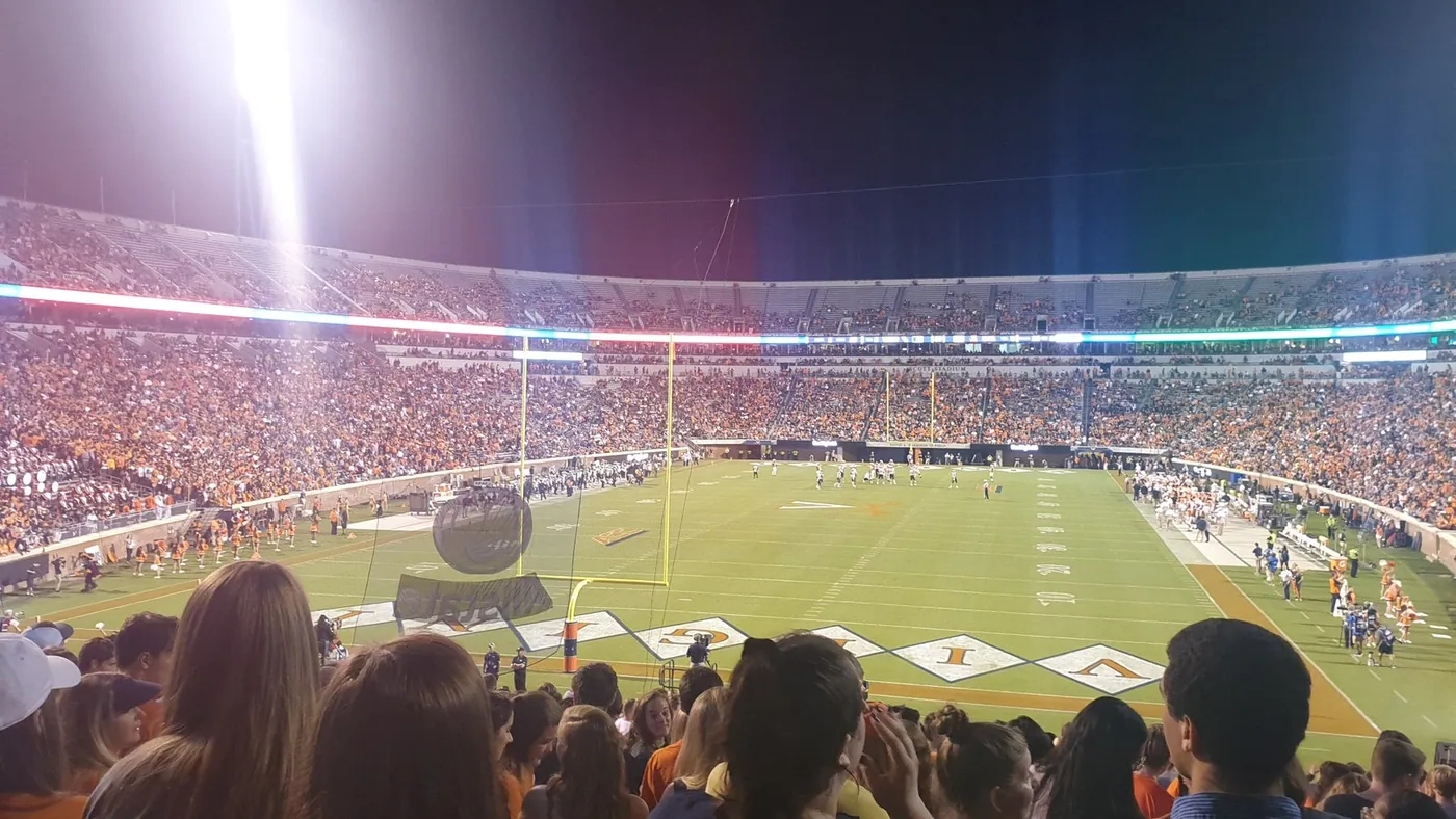 Illustration: an American football stadium under the lights (not SoFi Stadium).