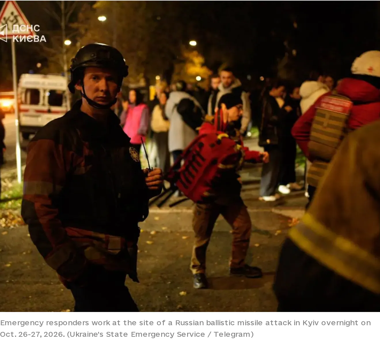 Responders at the strike site; image via Kyiv Independent.